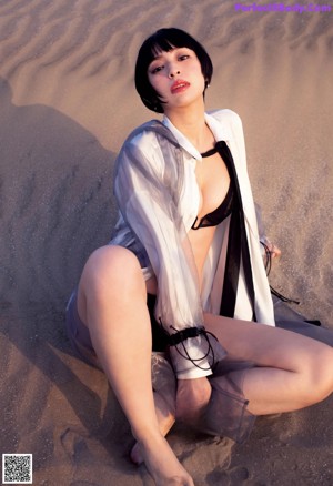 A woman in a green sweater is posing for a picture.