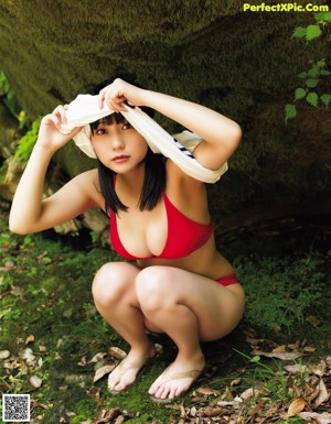 A woman in a white shirt is posing for a magazine cover.