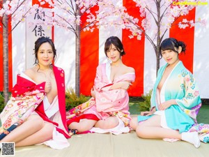 A woman in a pink kimono posing for the camera.