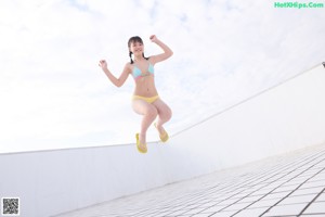 A woman in a bikini posing for a picture.