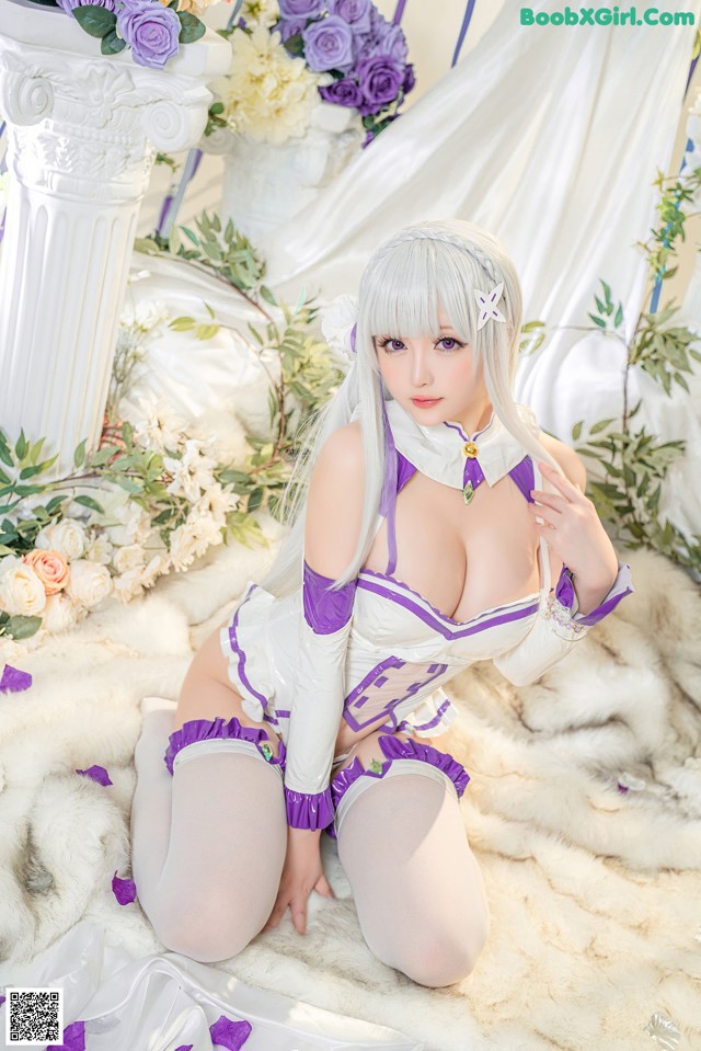 A woman in a white and purple outfit sitting on a fur rug.