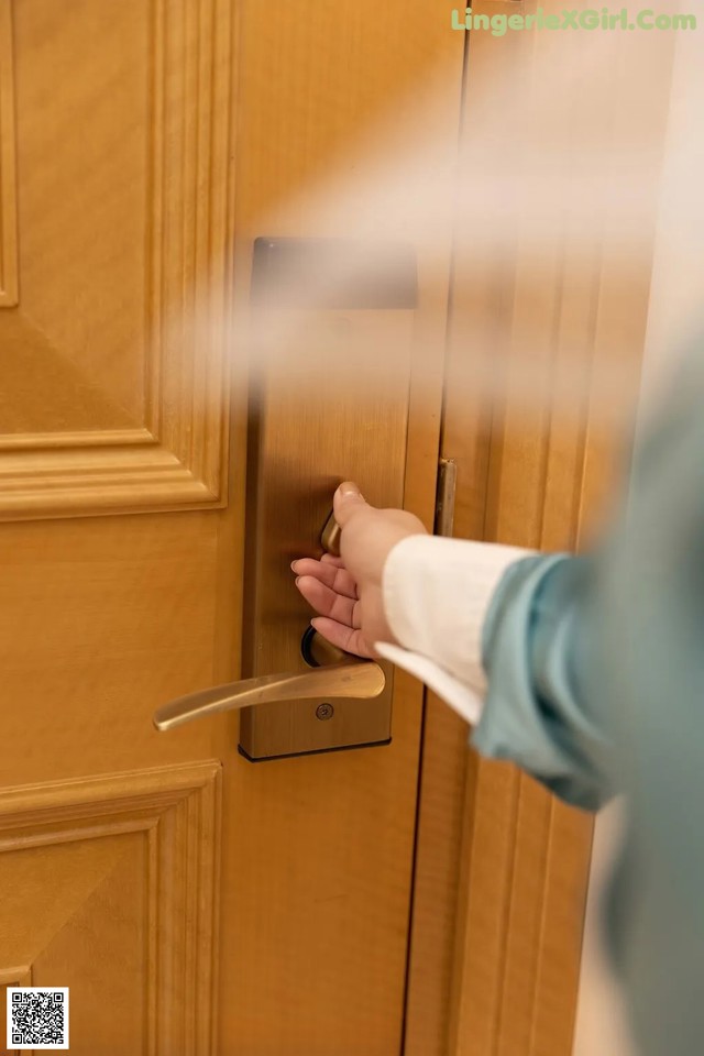 A person is opening a door with a steam cleaner.