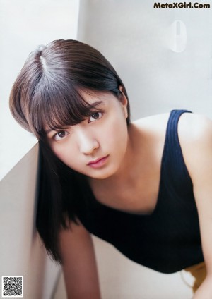 A woman laying on the floor in a blue shirt.