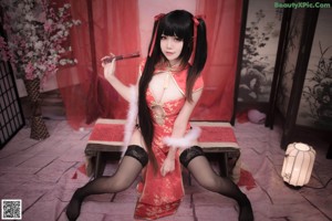 A woman in a maid outfit holding a broom.