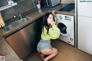 A woman sitting on top of a blue couch.