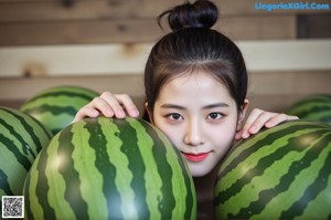 A woman in a pink bikini sitting next to a pile of watermelons.