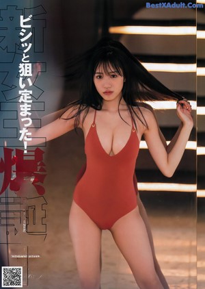A woman in a red bikini sitting on a set of stairs.