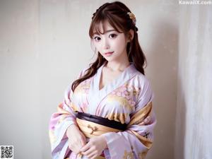 A woman in a purple kimono posing for a picture.