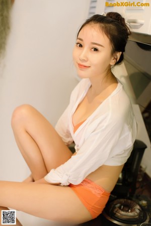 A woman in a white towel is posing for the camera.