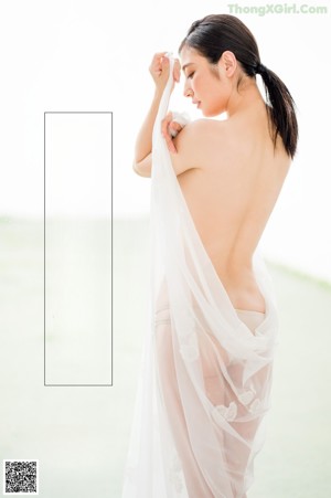 A woman in a white lingerie posing for a magazine.
