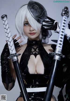 A woman in a black and white outfit holding a sword.