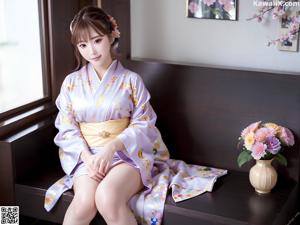 A woman in a blue kimono posing for the camera.