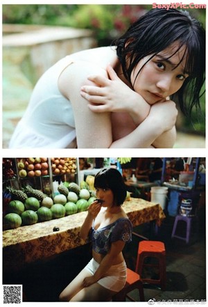 A woman in a white dress sitting on the ground.