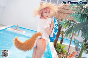 A woman in a bikini with a fox tail.