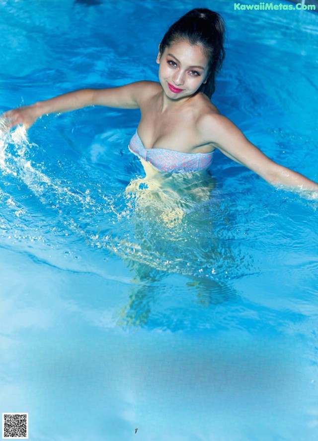 A woman in a bikini in a swimming pool.