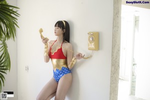 A woman in a red and blue bathing suit posing for a picture.