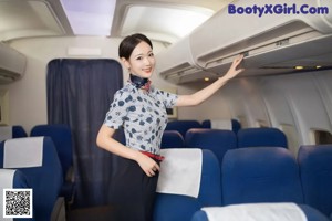 A woman in a red bra and black skirt on an airplane.